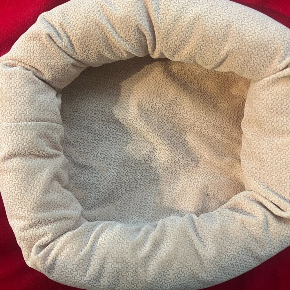 Gently used small dog or cat bed. Small round dog bed in a light color.